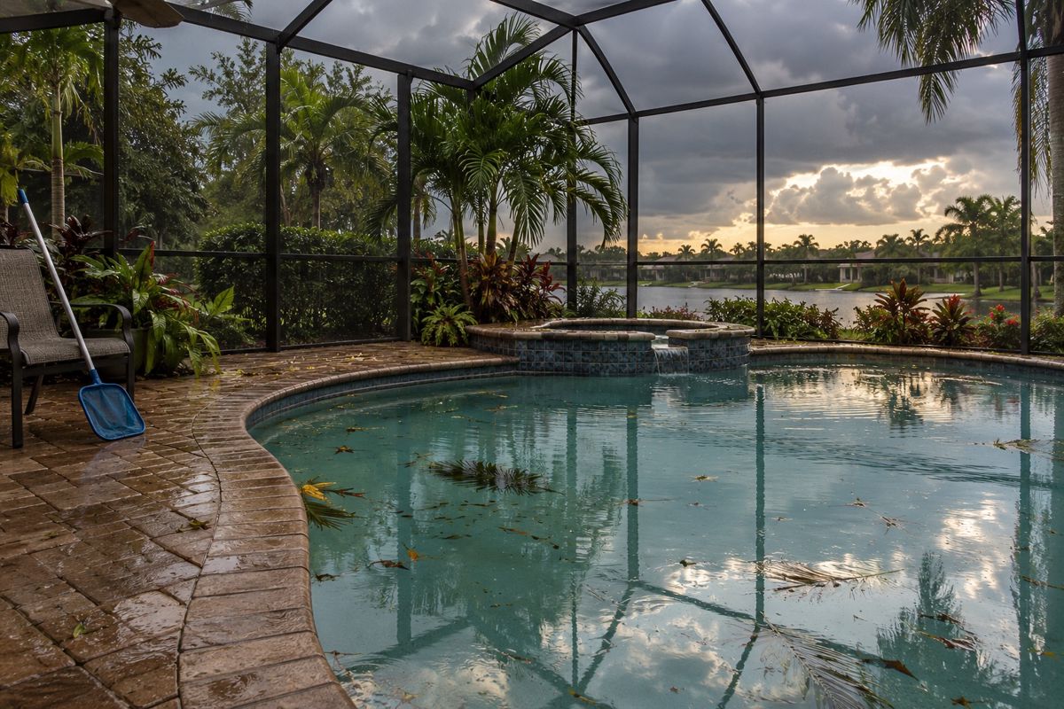 Lanai pool with leaves on the water after a summer storm